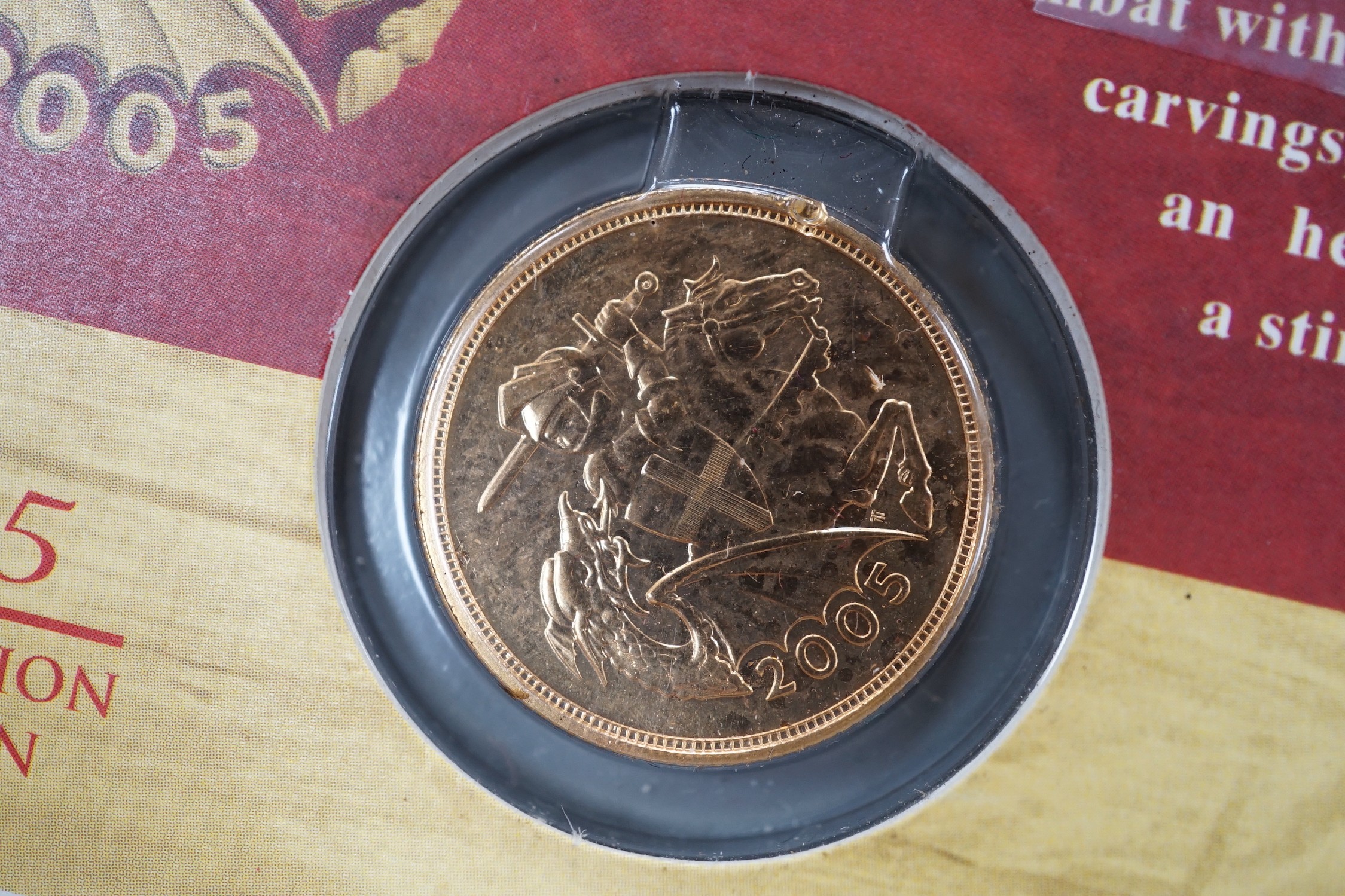 A 2005 gold sovereign, sealed in presentation card.